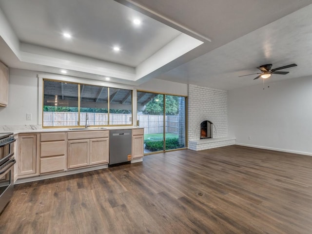 3101 Oak Hill Rd, Carrollton, TX 75007 - kitchen with stainless steel appliances, a sink, light brown cabinetry, a tray ceiling, and dark wood-style floors