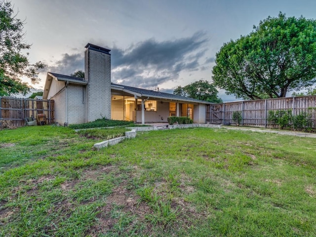 3101 Oak Hill Rd, Carrollton, TX 75007 - rear view of property with a chimney and brick siding