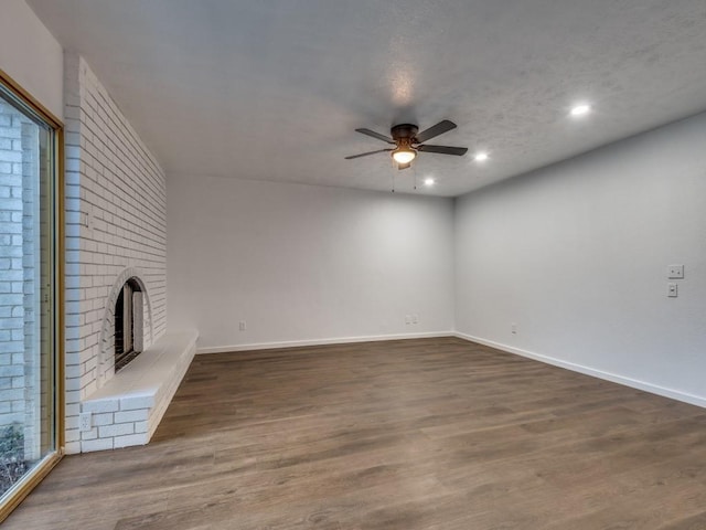 3101 Oak Hill Rd, Carrollton, TX 75007 - unfurnished living room with ceiling fan, dark wood finished floors, recessed lighting, baseboards, and a brick fireplace