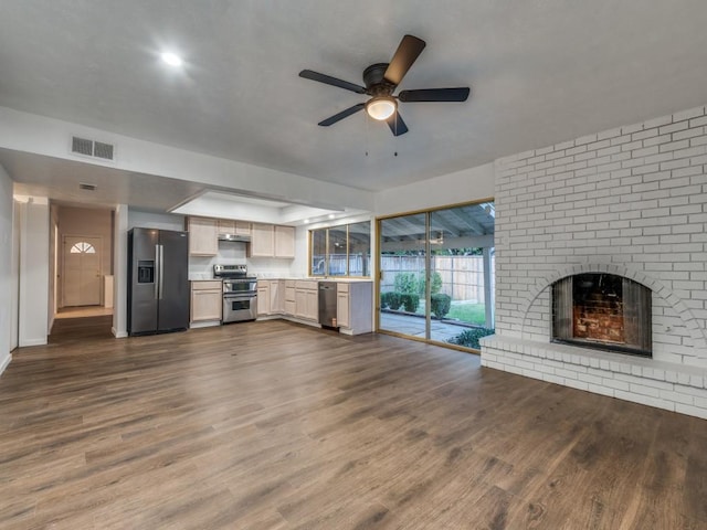 3101 Oak Hill Rd, Carrollton, TX 75007 - unfurnished living room featuring dark wood-style flooring, ceiling fan, a brick fireplace, baseboards, and a sink