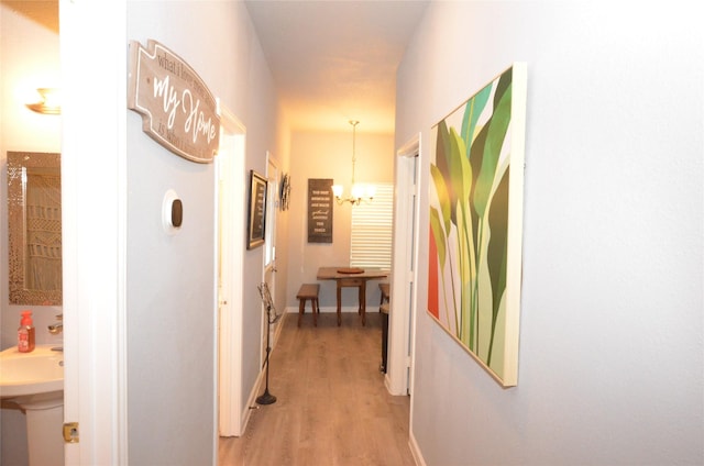 702 N Tennessee St, Mckinney, TX 75069 - corridor with light wood finished floors and a chandelier