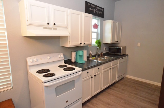 702 N Tennessee St, Mckinney, TX 75069 - kitchen with white appliances, ventilation hood, a sink, white cabinets, and wood finished floors