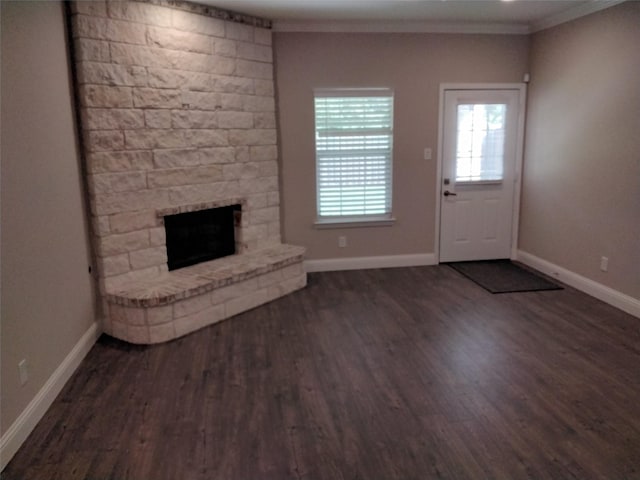 901 E Jefferson St, Van Alstyne, TX 75495 - unfurnished living room featuring a fireplace, baseboards, dark wood-type flooring, and crown molding