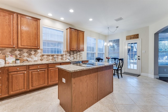 5801 Maidstone Dr, Richardson, TX 75082 - kitchen featuring light tile patterned floors, backsplash, recessed lighting, brown cabinetry, and light stone counters
