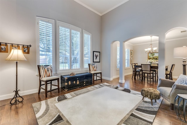 5801 Maidstone Dr, Richardson, TX 75082 - living area with arched walkways, wood finished floors, crown molding, and a chandelier