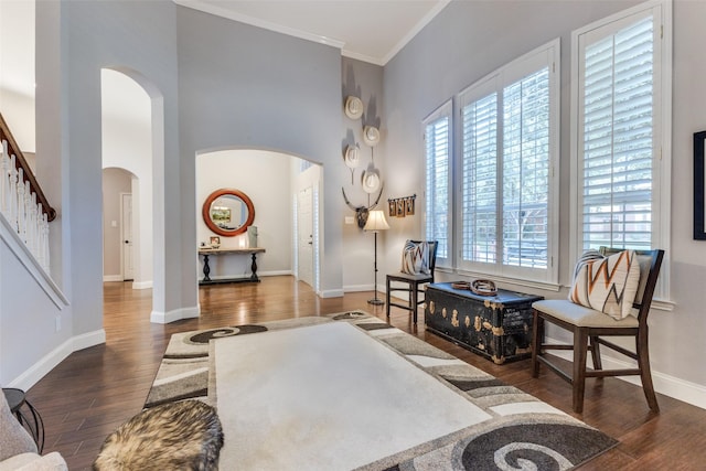 5801 Maidstone Dr, Richardson, TX 75082 - living area with arched walkways, wood finished floors, a high ceiling, ornamental molding, and stairway