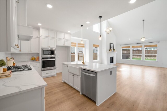3011 Whitby St, Prosper, TX 75078 - kitchen featuring appliances with stainless steel finishes, a sink, healthy amount of natural light, white cabinets, and recessed lighting