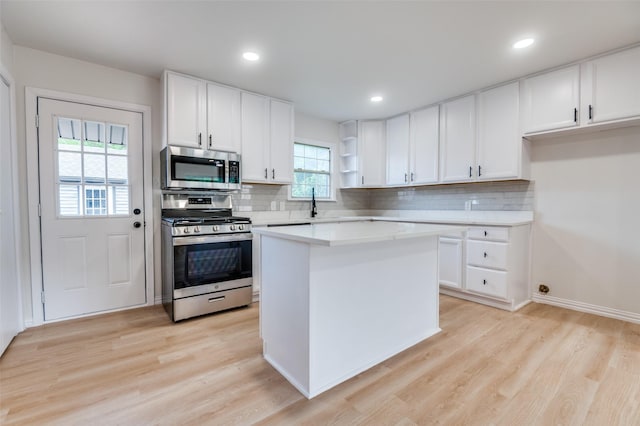 3524 Swan St, Haltom City, TX 76117 - kitchen featuring stainless steel appliances, open shelves, light wood-style floors, light countertops, and recessed lighting