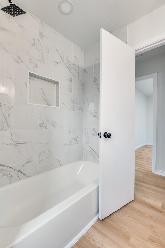 3524 Swan St, Haltom City, TX 76117 - bathroom featuring shower / washtub combination and wood finished floors