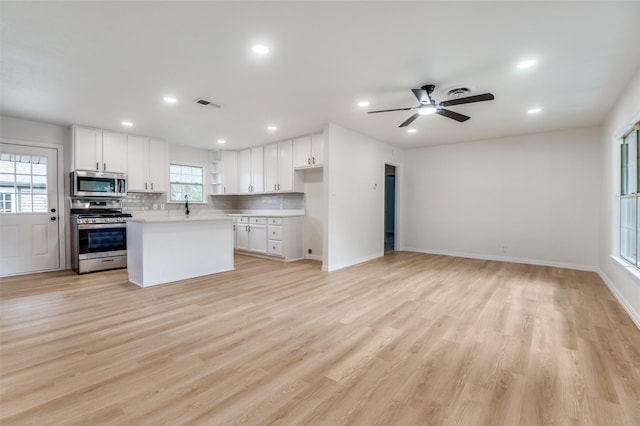 3524 Swan St, Haltom City, TX 76117 - kitchen with stainless steel appliances, plenty of natural light, light countertops, white cabinets, and recessed lighting