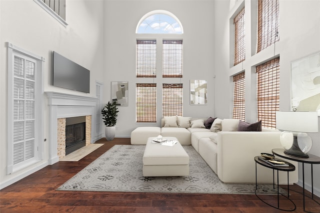 4688 Thanksgiving Ln, Plano, TX 75024 - living area featuring a high ceiling, wood finished floors, a premium fireplace, and baseboards