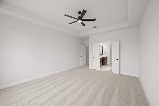 366 Paddle Boat Dr, Granbury, TX 76048 - unfurnished bedroom with a tray ceiling, light colored carpet, baseboards, and ensuite bathroom