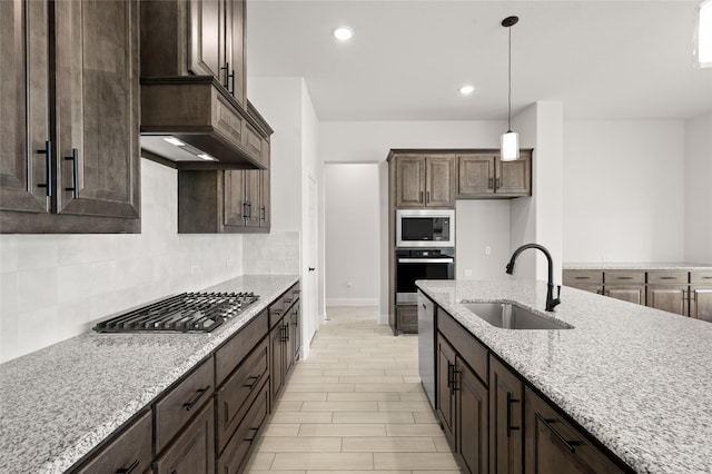 366 Paddle Boat Dr, Granbury, TX 76048 - kitchen featuring a sink, stainless steel appliances, decorative backsplash, dark brown cabinetry, and recessed lighting