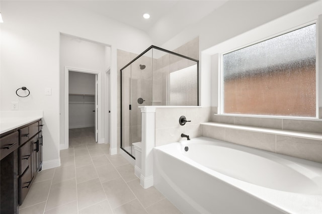 366 Paddle Boat Dr, Granbury, TX 76048 - bathroom featuring a garden tub, a stall shower, vanity, tile patterned floors, and a spacious closet
