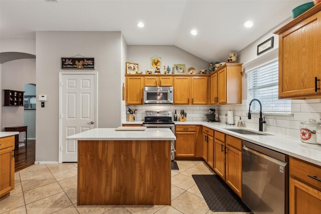 13137 Fencerow Rd, Fort Worth, TX 76244 - kitchen featuring stainless steel appliances, a sink, backsplash, a kitchen island, and arched walkways