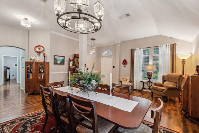 13137 Fencerow Rd, Fort Worth, TX 76244 - dining room featuring dark wood-style floors, a chandelier, arched walkways, and vaulted ceiling