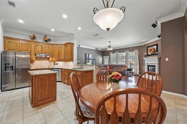 7917 Chapelwood Dr, North Richland Hills, TX 76182 - dining room featuring a ceiling fan, ornamental molding, a glass covered fireplace, light tile patterned floors, and recessed lighting