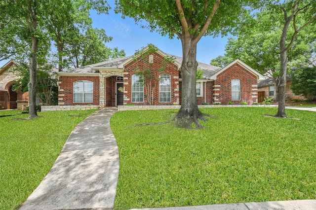 7917 Chapelwood Dr, North Richland Hills, TX 76182 - view of front facade with brick siding, a front lawn, and roof with shingles