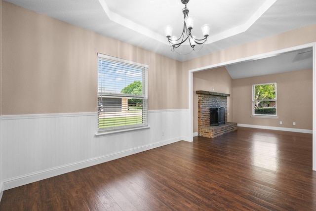 310 Singletree St, Highland Village, TX 75077 - unfurnished living room with a chandelier, wood finished floors, wainscoting, a fireplace, and a raised ceiling