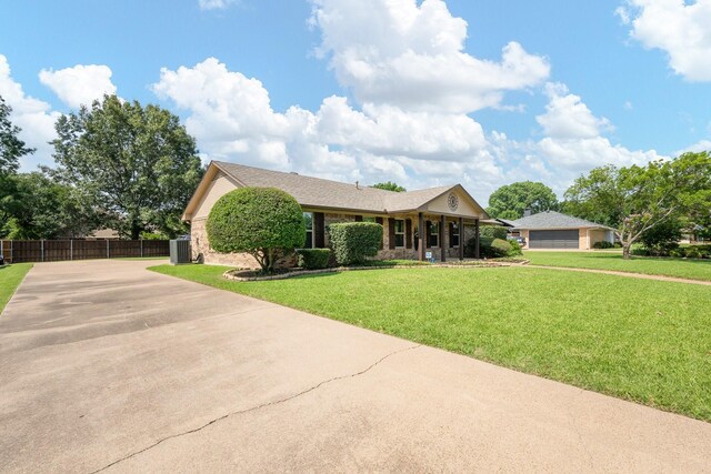 310 Singletree St, Highland Village, TX 75077 - view of front of property with concrete driveway, central air condition unit, and brick siding