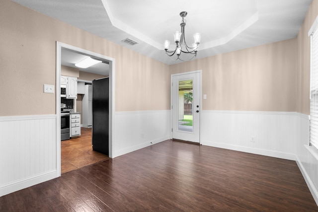 310 Singletree St, Highland Village, TX 75077 - unfurnished room with a chandelier, wainscoting, dark wood-type flooring, and a raised ceiling