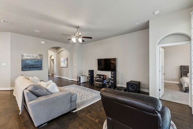 1117 Summer Ln, Mckinney, TX 75071 - living room with arched walkways, ceiling fan, baseboards, and dark wood-type flooring