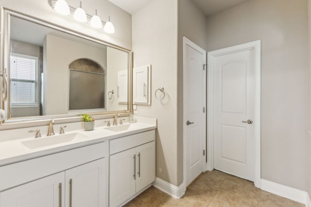 1117 Summer Ln, Mckinney, TX 75071 - full bath featuring double vanity, baseboards, and tile patterned floors