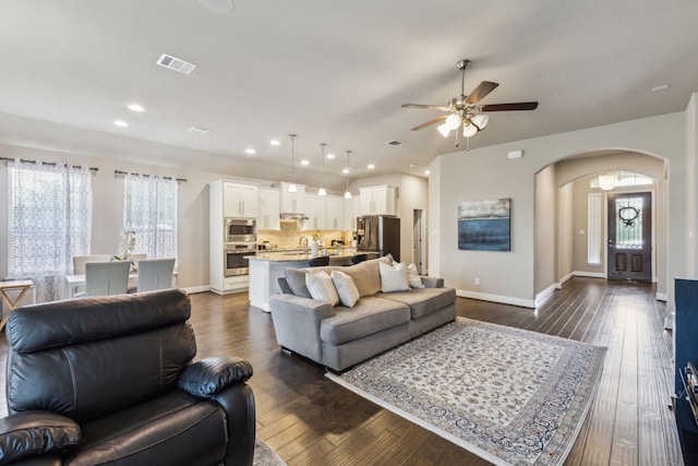 1117 Summer Ln, Mckinney, TX 75071 - living area featuring arched walkways, ceiling fan, baseboards, dark wood finished floors, and recessed lighting