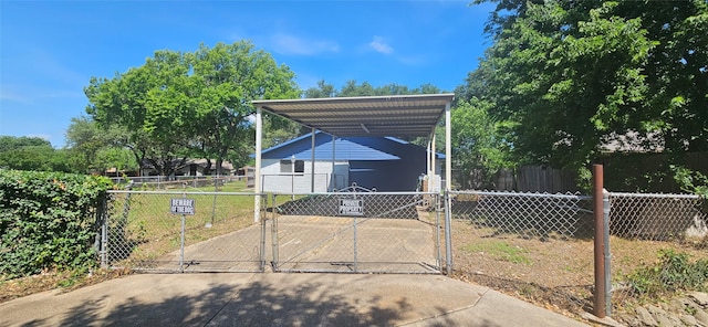 402 Ivy Way, Garland, TX 75043 - view of parking with a carport, concrete driveway, and a gate