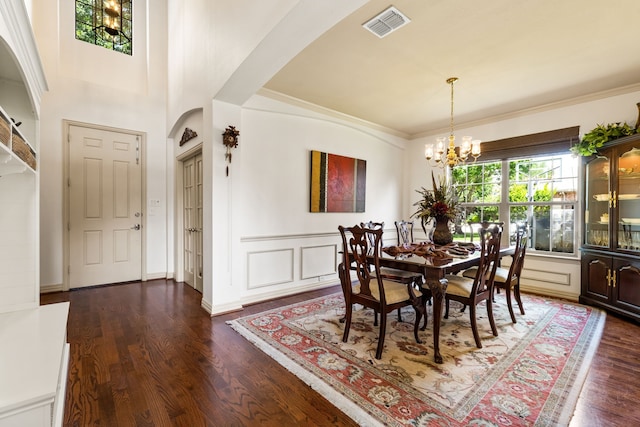 1765 Mustang Trl, Frisco, TX 75033 - dining space with a chandelier, dark wood-style flooring, arched walkways, and ornamental molding