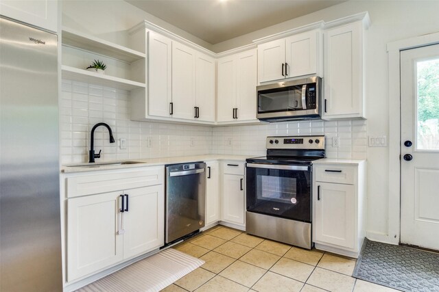 408 Peabody St, Hillsboro, TX 76645 - kitchen with stainless steel appliances, a sink, light countertops, and white cabinets
