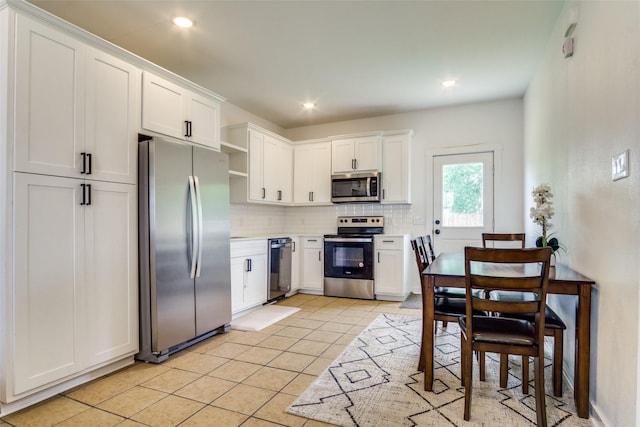 408 Peabody St, Hillsboro, TX 76645 - kitchen with stainless steel appliances, open shelves, tasteful backsplash, light tile patterned floors, and white cabinets