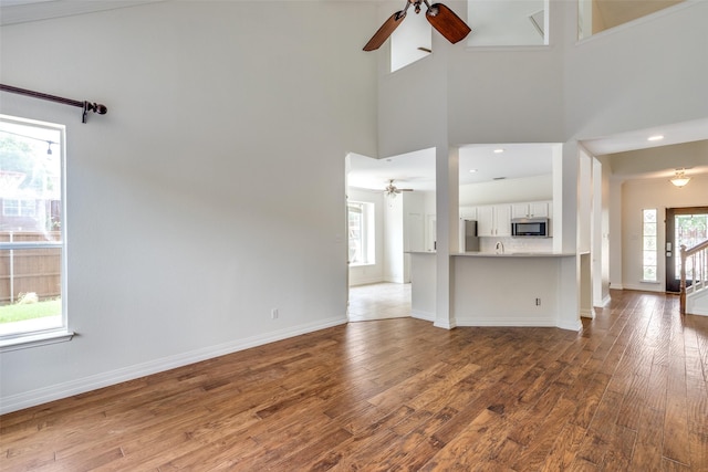 6500 Bolliger Ct, Frisco, TX 75035 - kitchen featuring stainless steel appliances, a sink, backsplash, white cabinetry, and light stone countertops