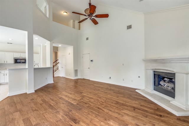 6500 Bolliger Ct, Frisco, TX 75035 - kitchen with stainless steel appliances, tasteful backsplash, a sink, white cabinetry, and light countertops