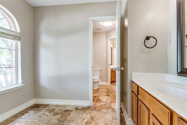 6500 Bolliger Ct, Frisco, TX 75035 - bathroom with toilet, vanity, healthy amount of natural light, and baseboards