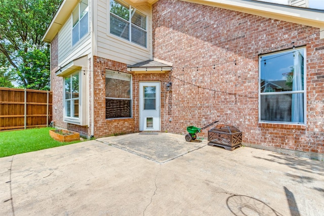 6500 Bolliger Ct, Frisco, TX 75035 - view of exterior entry featuring a patio and brick siding