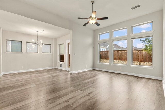 1725 Rolling Heights Ln, Fort Worth, TX 76008 - unfurnished living room with a chandelier, wood finished floors, baseboards, and a ceiling fan