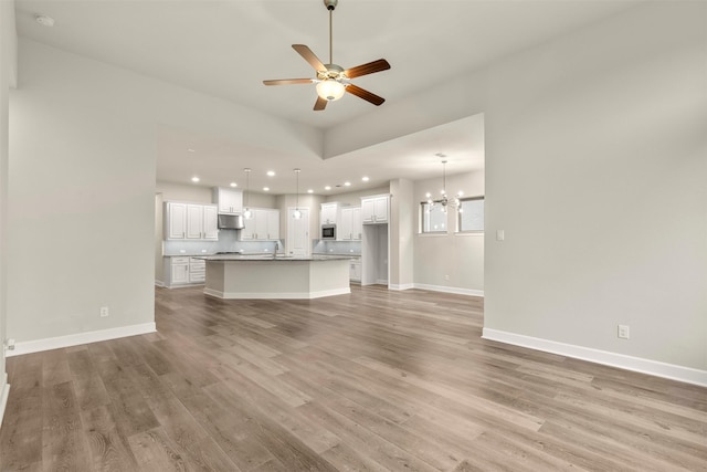 1725 Rolling Heights Ln, Fort Worth, TX 76008 - unfurnished living room featuring a chandelier, light wood-style flooring, recessed lighting, a ceiling fan, and baseboards