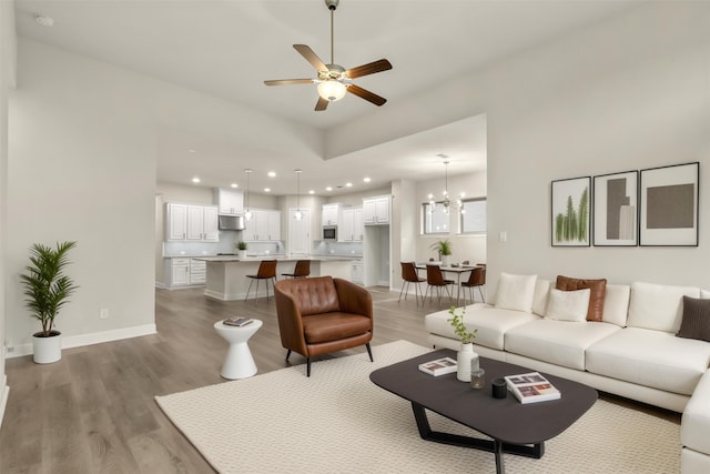 1725 Rolling Heights Ln, Fort Worth, TX 76008 - living room featuring light wood finished floors, a chandelier, a ceiling fan, recessed lighting, and baseboards