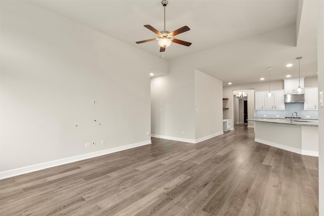 1725 Rolling Heights Ln, Fort Worth, TX 76008 - unfurnished living room featuring light wood-style flooring, a sink, a ceiling fan, recessed lighting, and baseboards