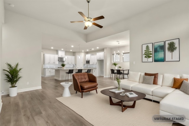 1725 Rolling Heights Ln, Fort Worth, TX 76008 - living room featuring light wood-style flooring, ceiling fan, recessed lighting, a chandelier, and baseboards