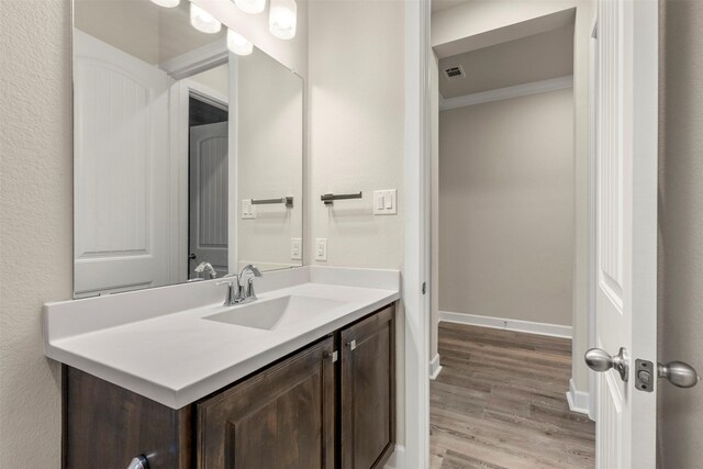 1725 Rolling Heights Ln, Fort Worth, TX 76008 - bathroom featuring vanity, wood finished floors, crown molding, and baseboards