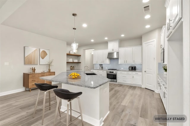 1725 Rolling Heights Ln, Fort Worth, TX 76008 - kitchen featuring under cabinet range hood, light wood-type flooring, stainless steel appliances, a sink, and white cabinetry