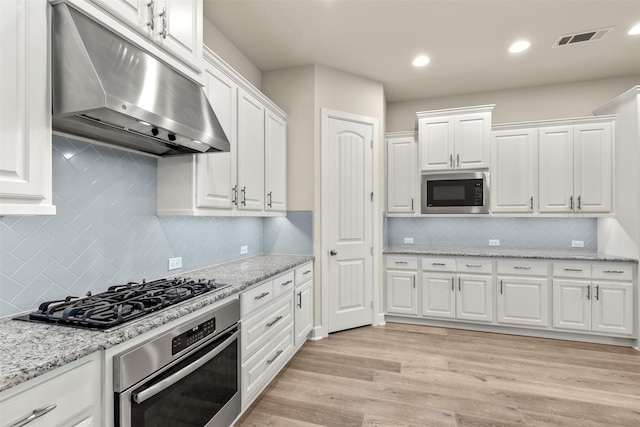 1725 Rolling Heights Ln, Fort Worth, TX 76008 - kitchen featuring appliances with stainless steel finishes, under cabinet range hood, white cabinetry, backsplash, and recessed lighting