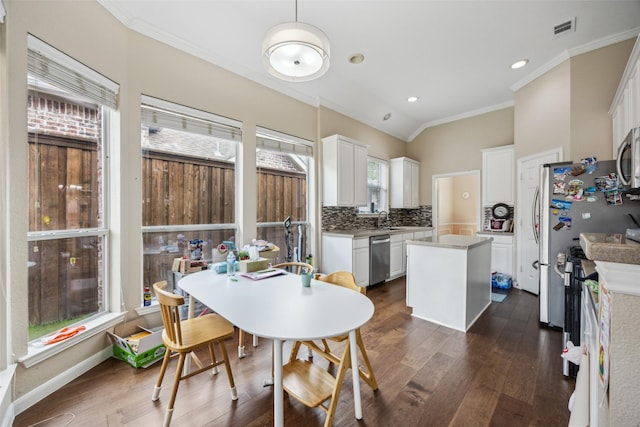4077 Truman Dr, Frisco, TX 75034 - dining area featuring dark wood-style floors, crown molding, and recessed lighting