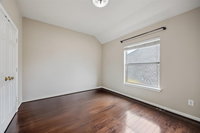 4077 Truman Dr, Frisco, TX 75034 - unfurnished bedroom with vaulted ceiling, dark wood-style floors, a closet, and baseboards