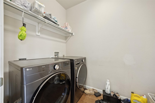4077 Truman Dr, Frisco, TX 75034 - laundry area with washing machine and clothes dryer, baseboards, and wood finished floors