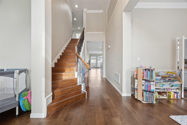 4077 Truman Dr, Frisco, TX 75034 - entrance foyer with crown molding, stairway, wood finished floors, baseboards, and recessed lighting
