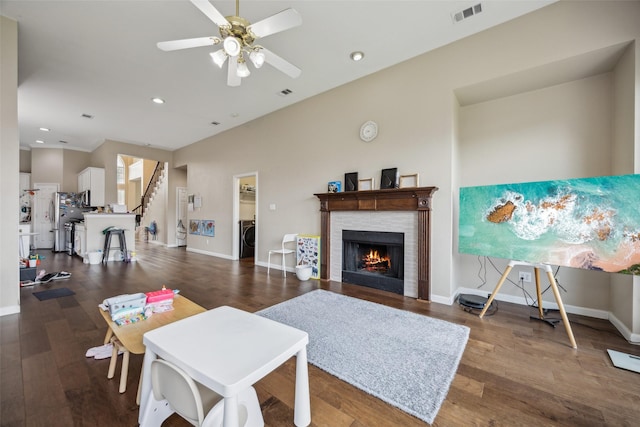 4077 Truman Dr, Frisco, TX 75034 - living room featuring washer / dryer, ceiling fan, a lit fireplace, wood finished floors, and recessed lighting