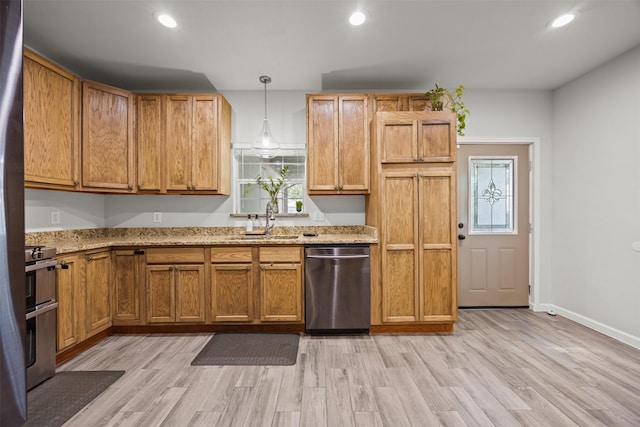 3208 Travis Ave, Fort Worth, TX 76110 - kitchen with appliances with stainless steel finishes, a sink, recessed lighting, light wood-style flooring, and light stone counters